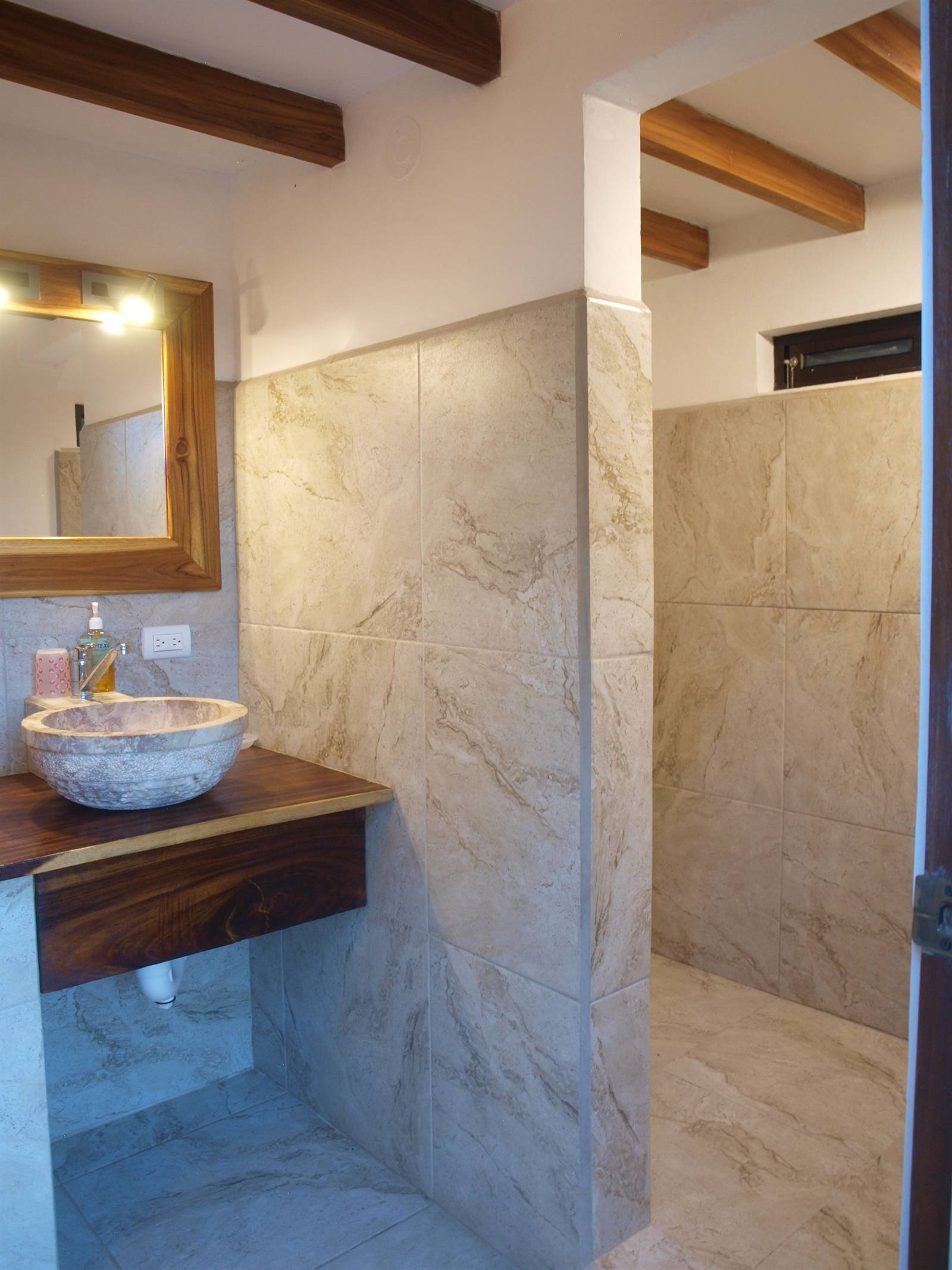 Bathroom with a stone sink and a wooden countertop
